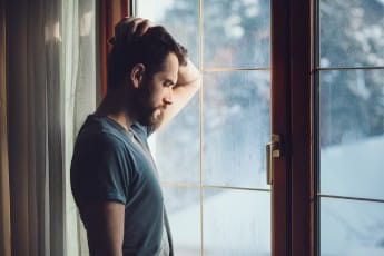 Understanding and Overcoming Men’s Pornography Addiction 8 man looking out window 558962893 2