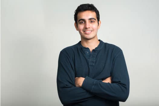 man smiling with arms folded
